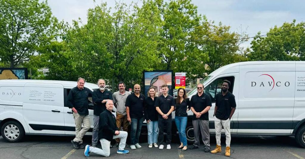 Some Daisy team members in front of two Davco vans