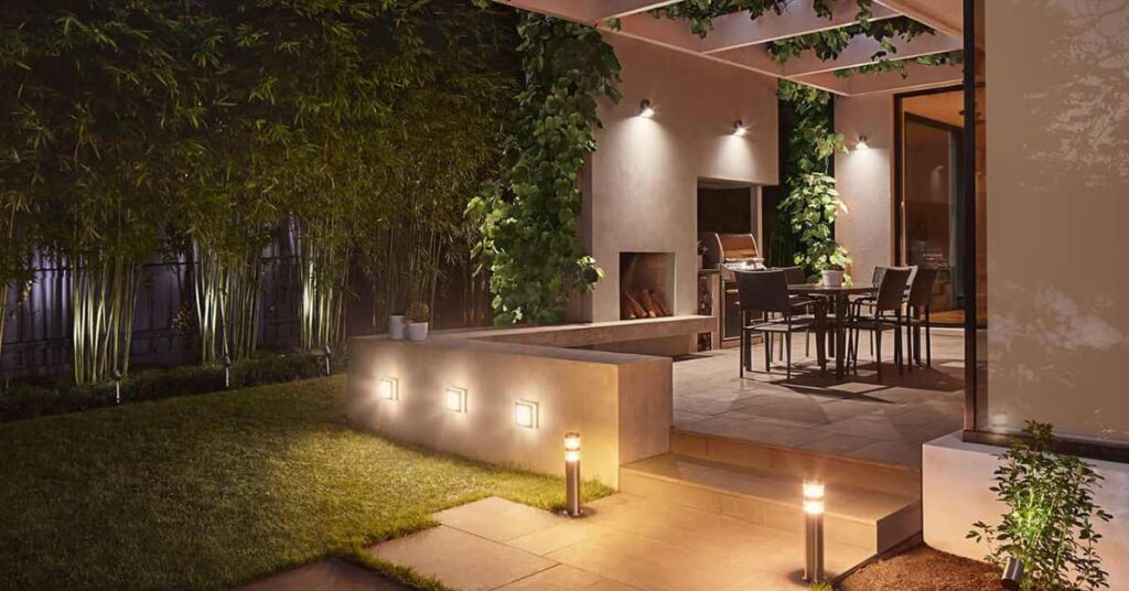 Outdoor patio area at night with a table and chairs with ambient outdoor lighting