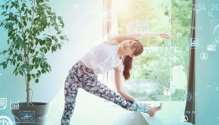 Woman working out with tech symbols overlaying the image