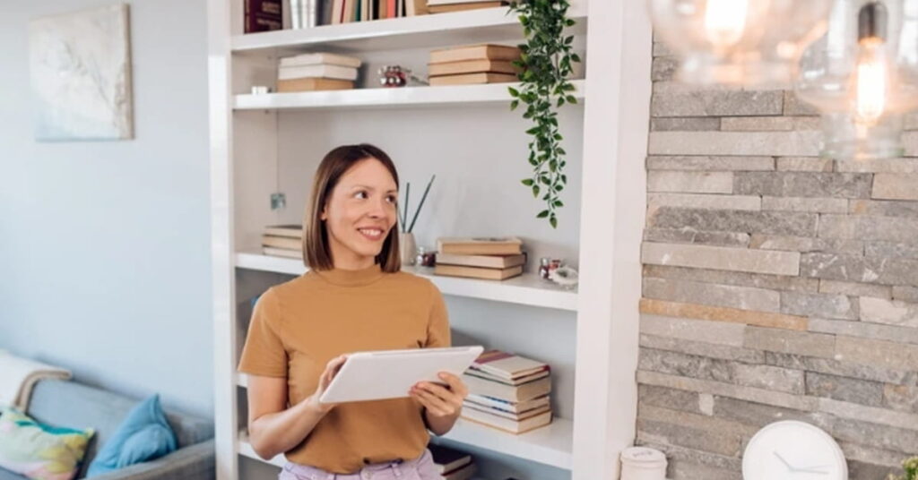 A happy woman adjusting her smart lighting settings