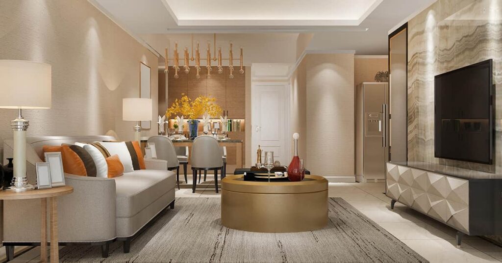 Living area with light colored couch to the left, ad round coffee table i the middle, a dining area in the back and a flat screen TV on the wall to the right with linear lighting overhead