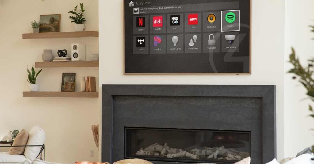 Flat screen Smart TV on a white wall above a fireplace with a shelf to the left of it with various things on it