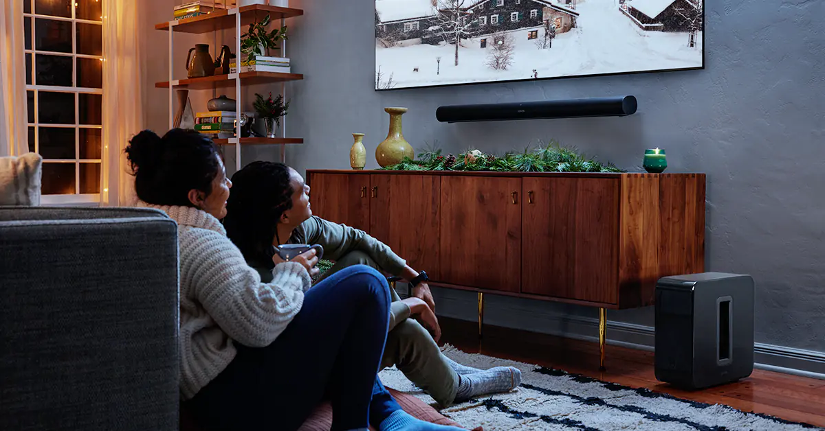 Two people watching TV in a dark room during the holidays